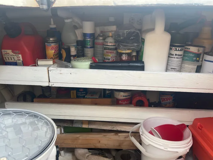  Yacht Photos Pics Storage shelves with various cleaning supplies and tools on a Cherubini Independence, 1998.