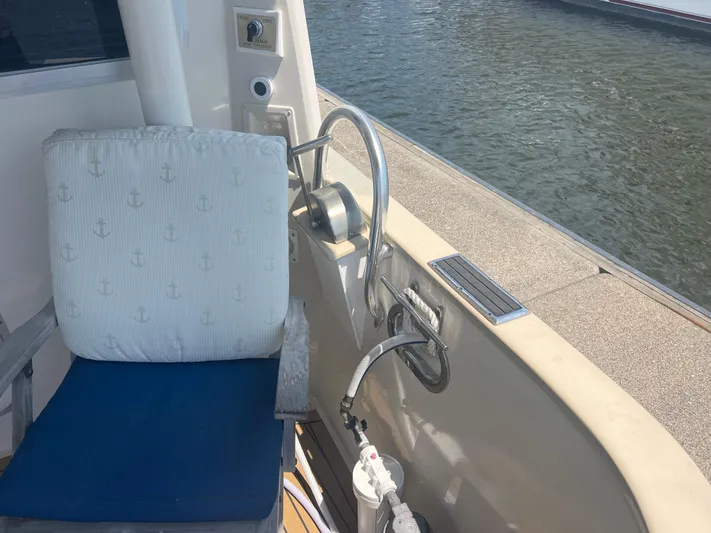  Yacht Photos Pics Cherubini Independence 1998 boat deck with nautical-themed chair and water view.