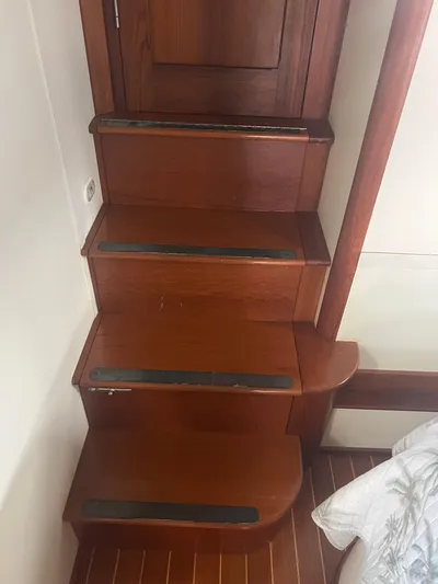  Yacht Photos Pics Wooden stairs inside a 1998 Cherubini Independence boat, featuring anti-slip strips.