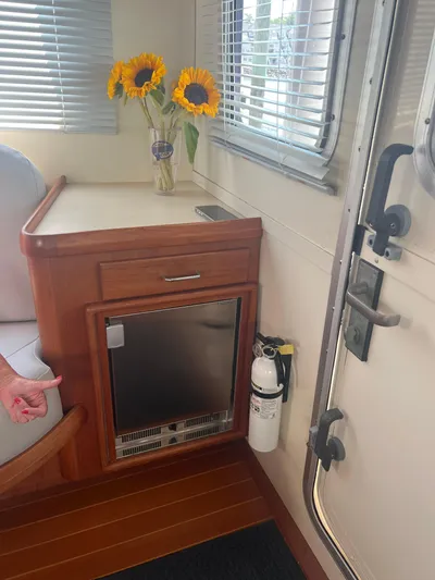  Yacht Photos Pics Interior of 1998 Cherubini Independence with sunflowers, wooden cabinetry, and fire extinguisher.