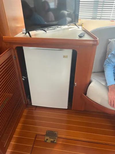  Yacht Photos Pics Interior of 1998 Cherubini Independence with mini fridge and TV on wooden cabinetry.