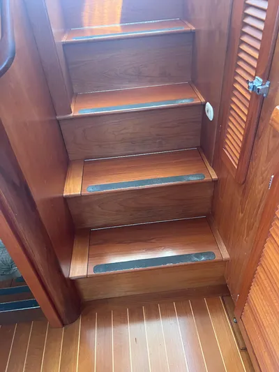  Yacht Photos Pics Wooden stairs inside a 1998 Cherubini Independence boat, featuring non-slip strips.
