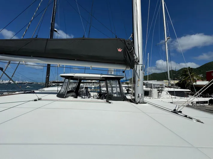 Bluevana Yacht Photos Pics 2023 Lagoon 42 catamaran docked at marina under clear blue sky.