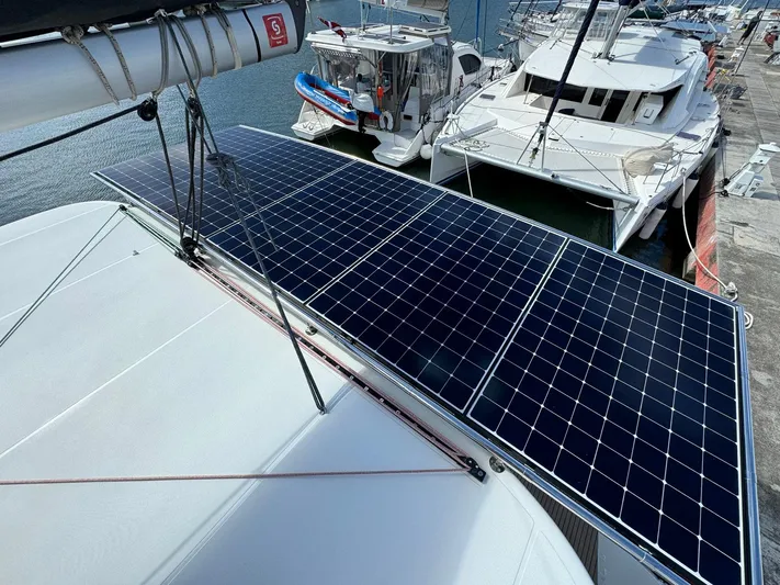 Bluevana Yacht Photos Pics 2023 Lagoon 42 catamaran with solar panels docked at marina.