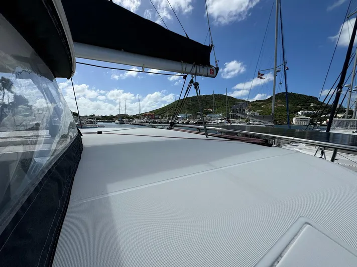 Bluevana Yacht Photos Pics 2023 Lagoon 42 catamaran deck with scenic marina and hills in the background.