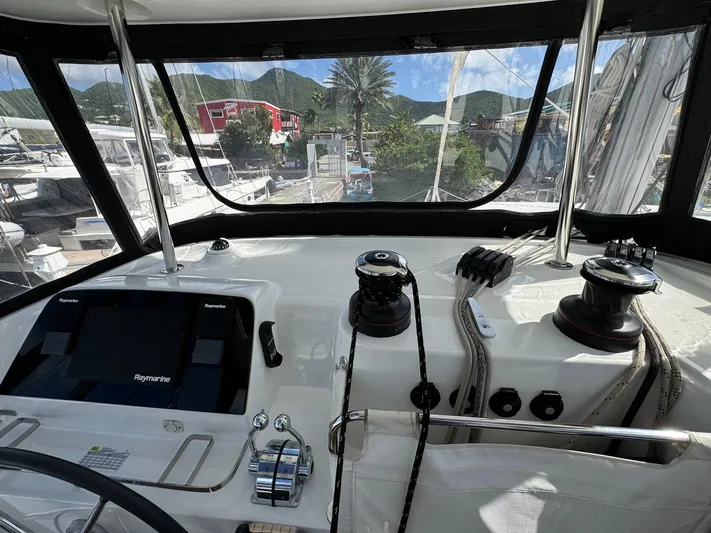 Bluevana Yacht Photos Pics Cockpit view of 2023 Lagoon 42 catamaran with navigation equipment and winches.