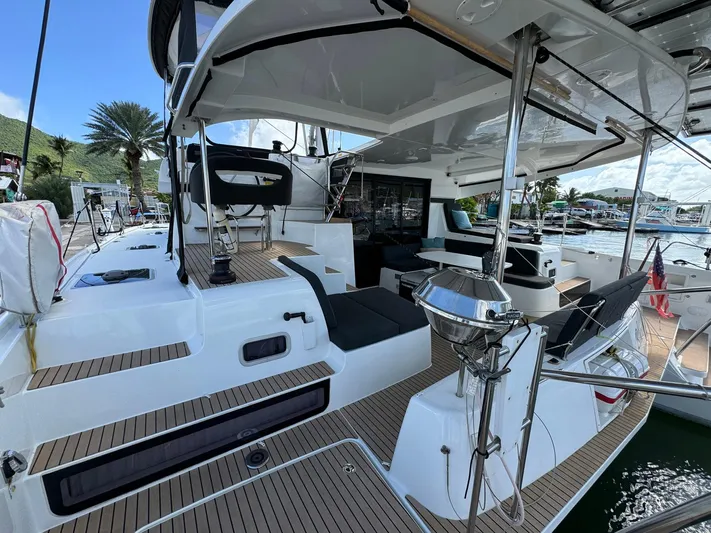 Bluevana Yacht Photos Pics 2023 Lagoon 42 yacht with spacious deck and modern design in marina setting.