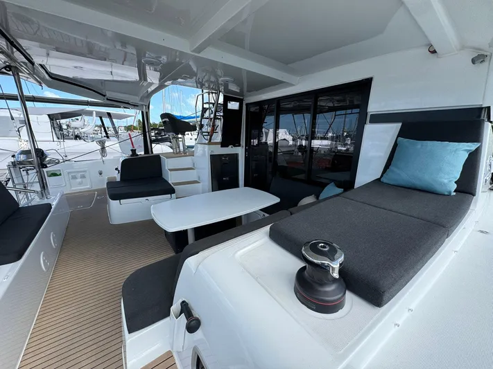 Bluevana Yacht Photos Pics 2023 Lagoon 42 yacht interior with modern seating and sleek design.