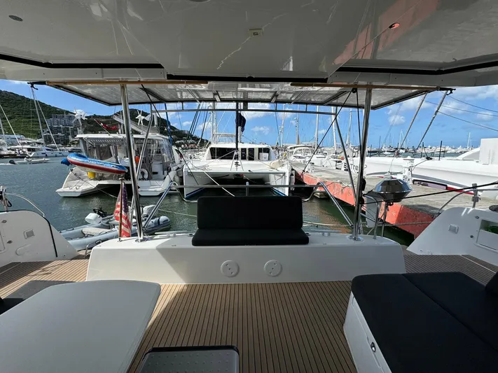 Bluevana Yacht Photos Pics 2023 Lagoon 42 catamaran docked at marina, featuring spacious deck and modern design.
