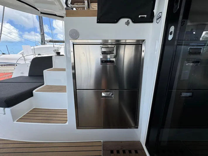 Bluevana Yacht Photos Pics 2023 Lagoon 42 yacht interior with stainless steel drawers and wooden steps.
