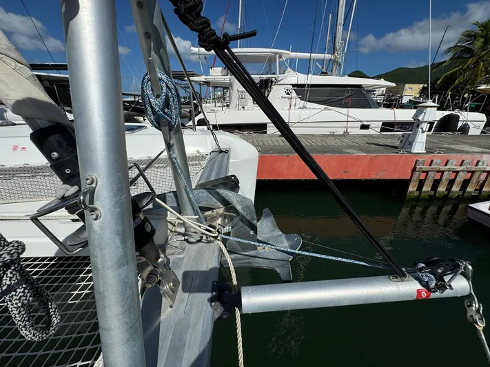 Bluevana Yacht Photos Pics 2023 Lagoon 42 catamaran docked, showing anchor and rigging details.