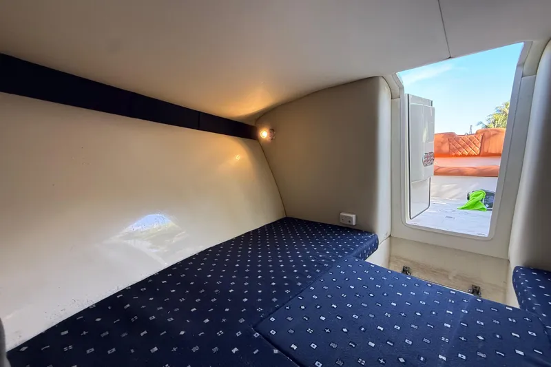  Yacht Photos Pics 2018 Chris-Craft Capri 27 cabin interior with patterned seating and open hatch.