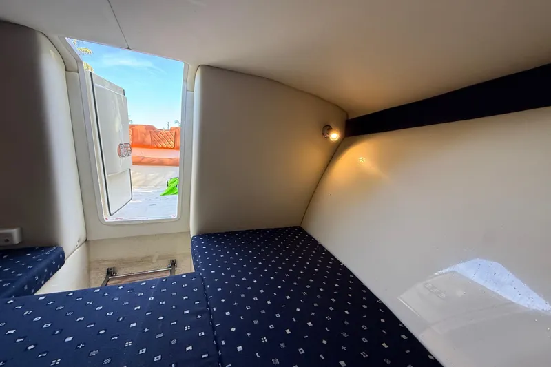  Yacht Photos Pics 2018 Chris-Craft Capri 27 cabin interior with patterned seating and ambient lighting.