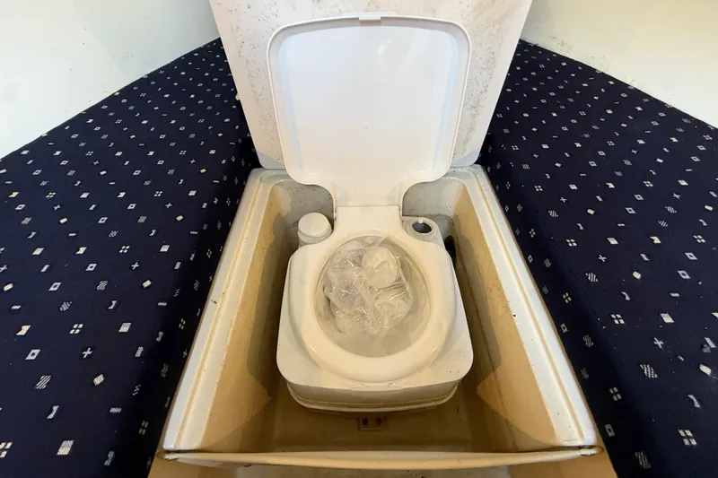  Yacht Photos Pics 2018 Chris-Craft Capri 27 boat interior with a compact toilet setup.