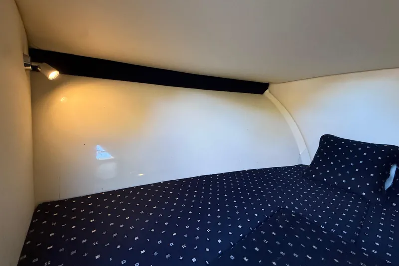  Yacht Photos Pics 2018 Chris-Craft Capri 27 cabin interior with cozy bed and reading light.