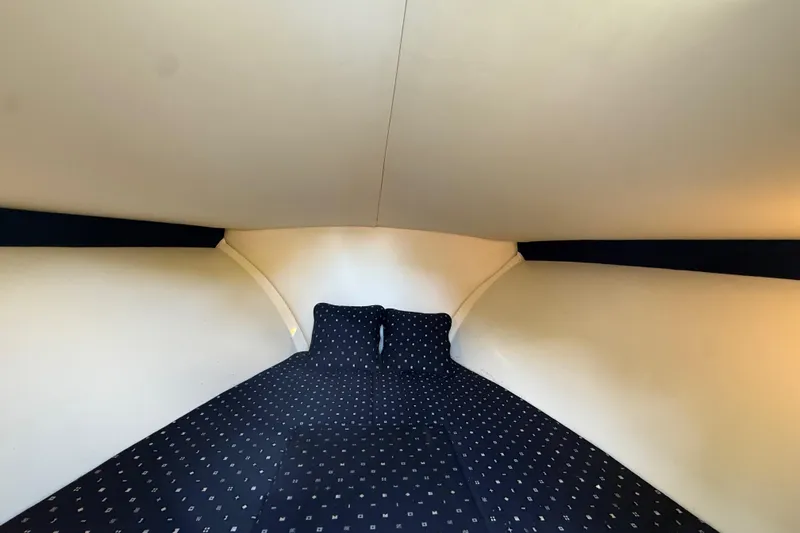  Yacht Photos Pics 2018 Chris-Craft Capri 27 cabin interior with cozy bedding.