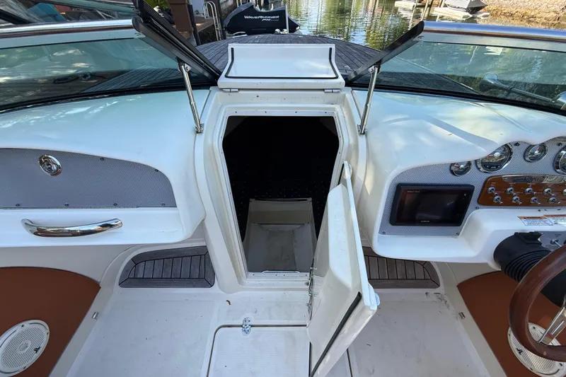  Yacht Photos Pics 2018 Chris-Craft Capri 27 boat interior with open cabin door and dashboard view.