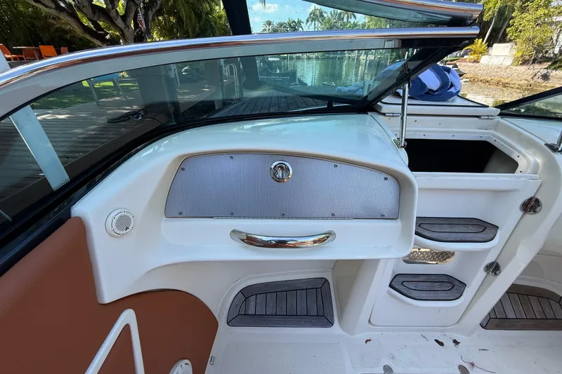  Yacht Photos Pics 2018 Chris-Craft Capri 27 interior with sleek dashboard and storage compartments.