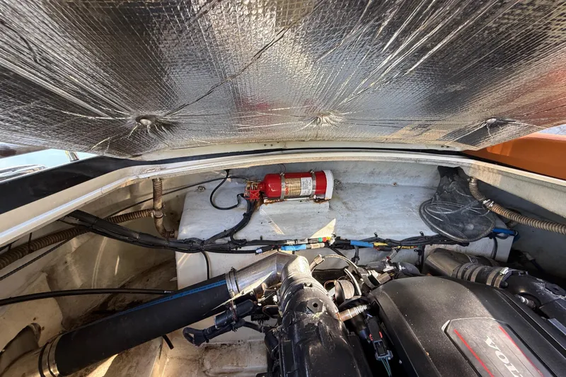  Yacht Photos Pics Engine compartment of a 2018 Chris-Craft Capri 27 with fire extinguisher and Volvo engine.