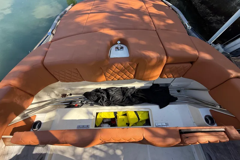  Yacht Photos Pics 2018 Chris-Craft Capri 27 boat with tan leather seating and storage compartments.