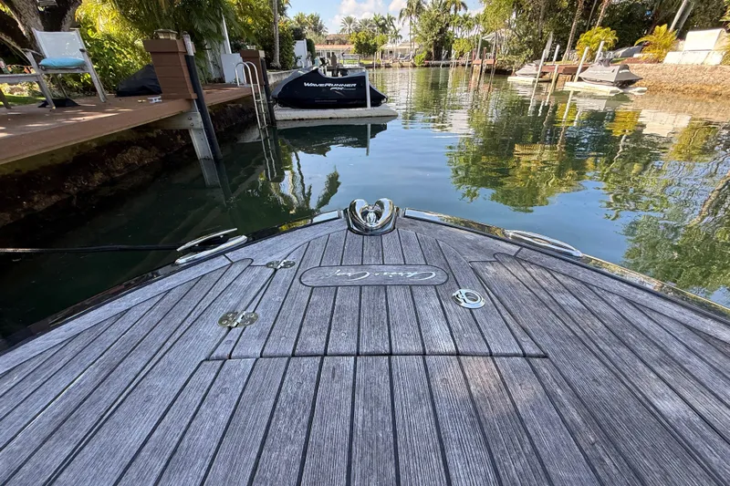  Yacht Photos Pics 2018 Chris-Craft Capri 27 boat docked in a serene, tropical canal setting.