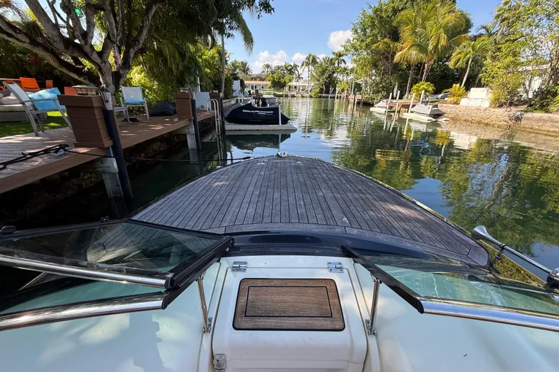  Yacht Photos Pics 2018 Chris-Craft Capri 27 boat docked in a scenic, tropical canal setting.