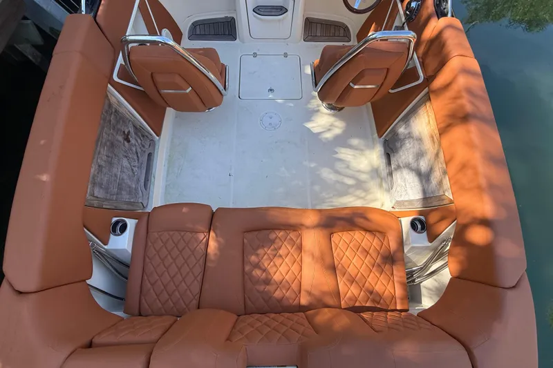  Yacht Photos Pics 2018 Chris-Craft Capri 27 boat interior with tan leather seating and wood accents.