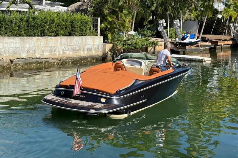  Yacht Photos Pics 2018 Chris-Craft Capri 27 boat on water, featuring sleek design and American flag.