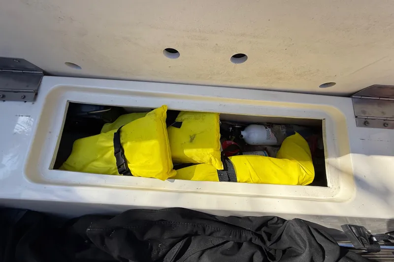  Yacht Photos Pics Storage compartment in Chris-Craft Capri 27 boat with yellow life jackets.