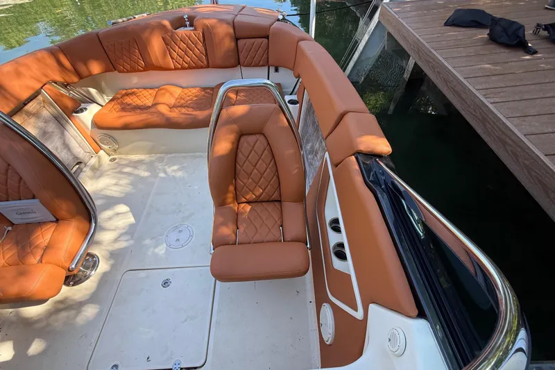  Yacht Photos Pics Interior of a 2018 Chris-Craft Capri 27 with brown leather seating.