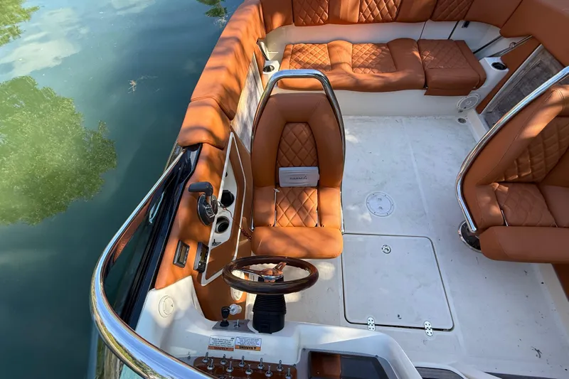  Yacht Photos Pics Interior of a 2018 Chris-Craft Capri 27 with brown leather seats.