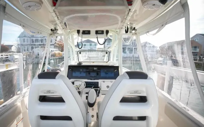  Yacht Photos Pics Interior view of 2022 Sailfish 290 CC boat cockpit with dual seats and control panel.