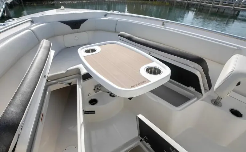  Yacht Photos Pics 2022 Sailfish 290 CC boat interior with seating and table.