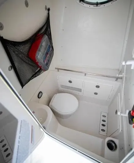  Yacht Photos Pics 2022 Sailfish 290 CC boat interior with compact marine toilet and storage.