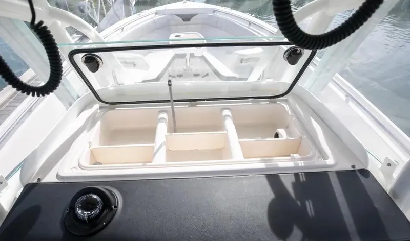  Yacht Photos Pics 2022 Sailfish 290 CC boat storage compartment with open lid, showcasing interior design.