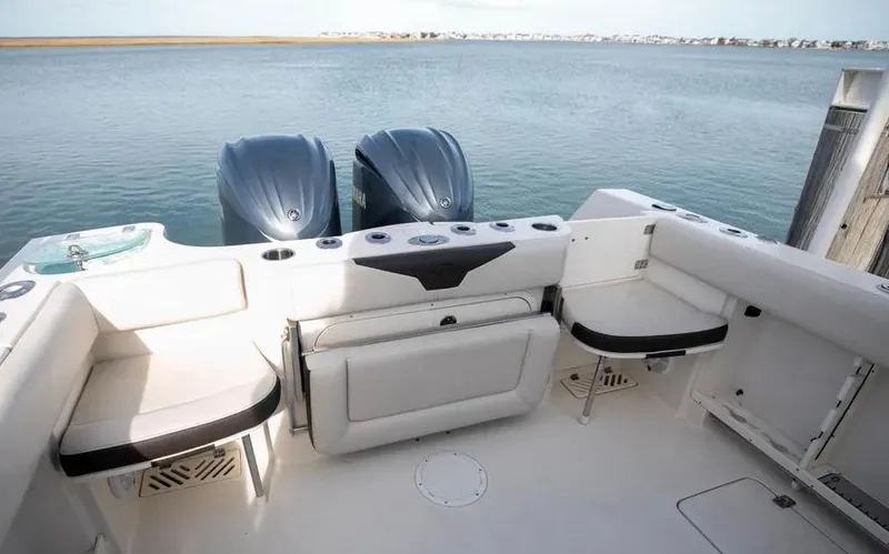  Yacht Photos Pics 2022 Sailfish 290 CC boat interior with dual engines and seating area.