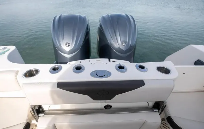  Yacht Photos Pics 2022 Sailfish 290 CC boat with dual outboard motors on calm water.