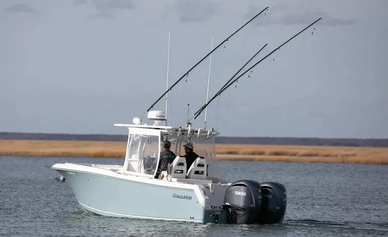  Yacht Photos Pics 2022 Sailfish 290 CC boat with fishing rods on a calm water body.