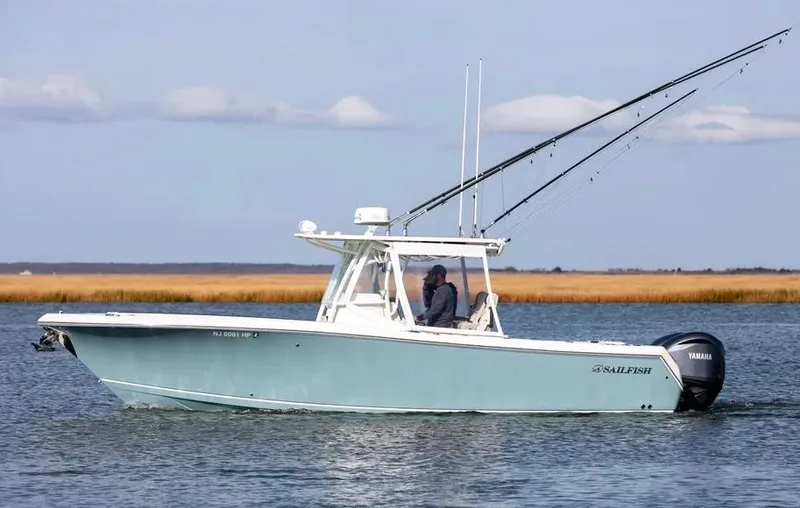  Yacht Photos Pics 2022 Sailfish 290 CC boat cruising on calm water with fishing rods.
