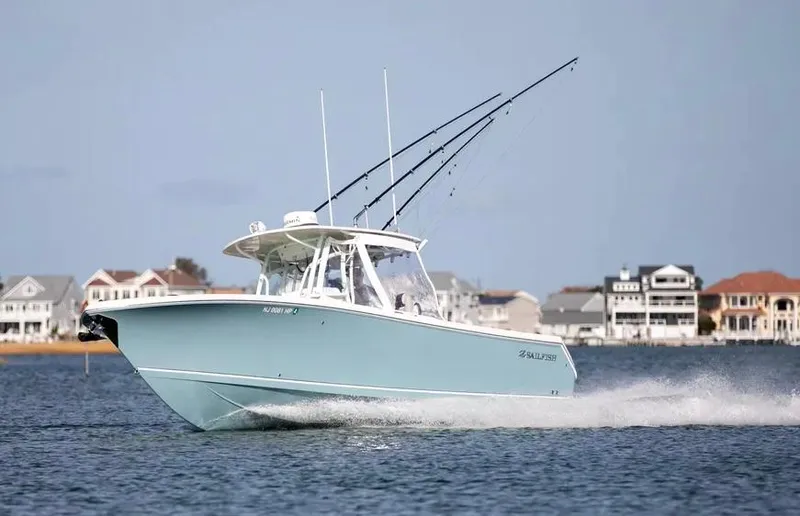  Yacht Photos Pics 2022 Sailfish 290 CC boat cruising on water near coastal homes.