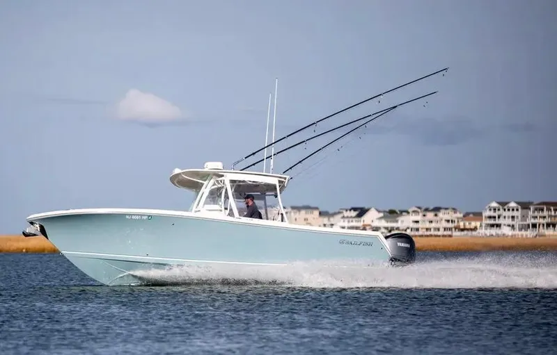  Yacht Photos Pics 2022 Sailfish 290 CC boat cruising on water near coastal homes.