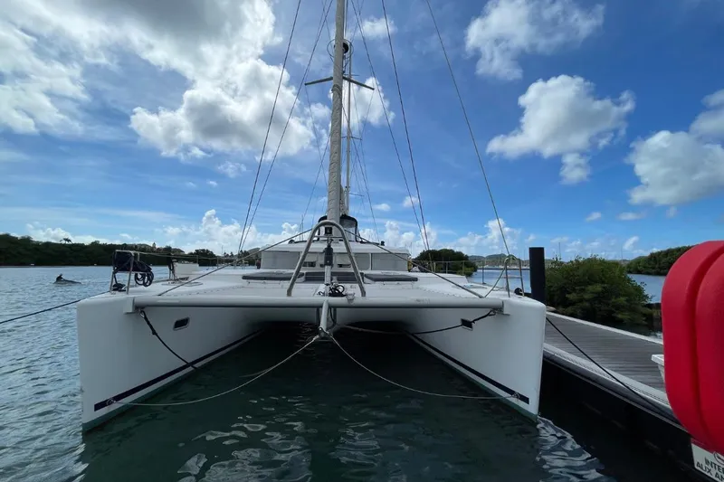 Tikiaora Yacht Photos Pics 2008 Lagoon 500 catamaran docked under a bright blue sky.