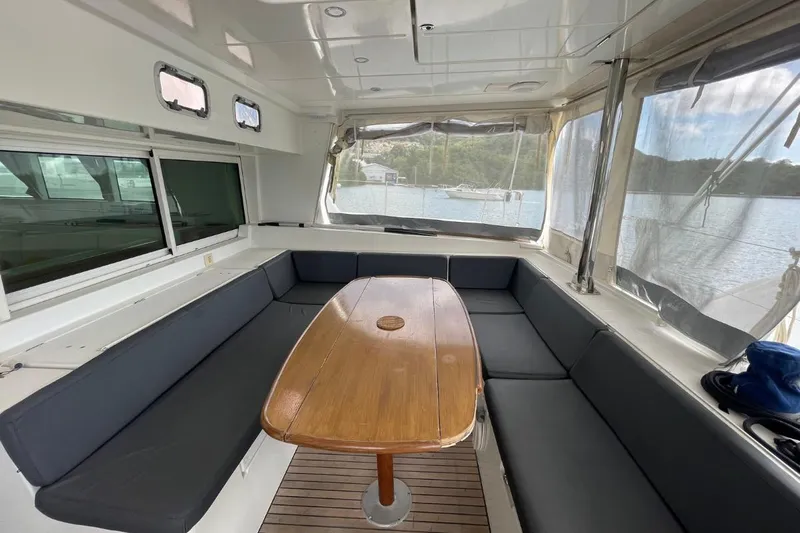 Tikiaora Yacht Photos Pics Spacious interior of 2008 Lagoon 500 catamaran with seating and wooden table.