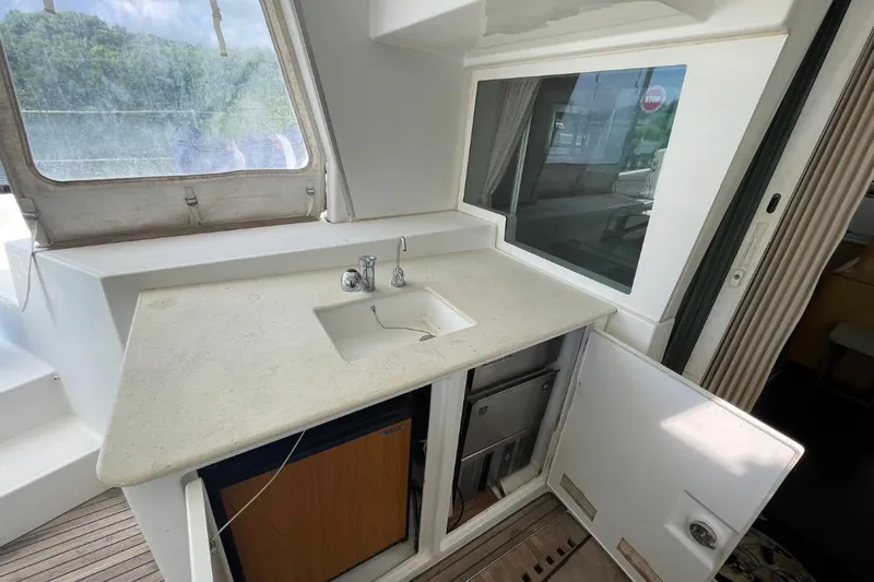Tikiaora Yacht Photos Pics 2008 Lagoon 500 yacht kitchenette with sink, countertop, and storage.