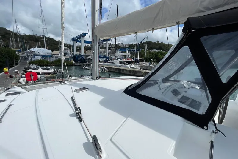 Tikiaora Yacht Photos Pics 2008 Lagoon 500 yacht docked at marina with clear skies and surrounding boats.