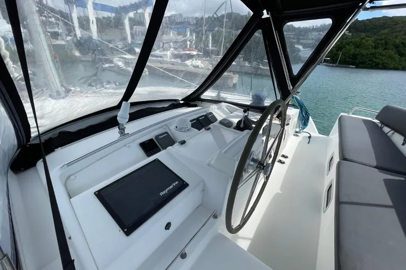 Tikiaora Yacht Photos Pics Helm of 2008 Lagoon 500 catamaran with navigation equipment and seating, docked in marina.