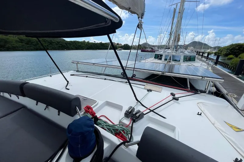 Tikiaora Yacht Photos Pics 2008 Lagoon 500 catamaran docked, featuring spacious deck and scenic waterfront view.