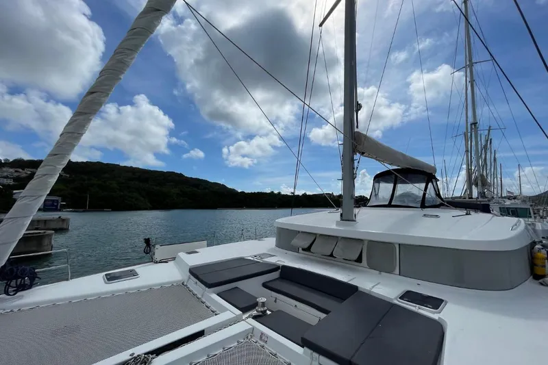 Tikiaora Yacht Photos Pics 2008 Lagoon 500 catamaran docked, featuring spacious deck and scenic waterfront view.