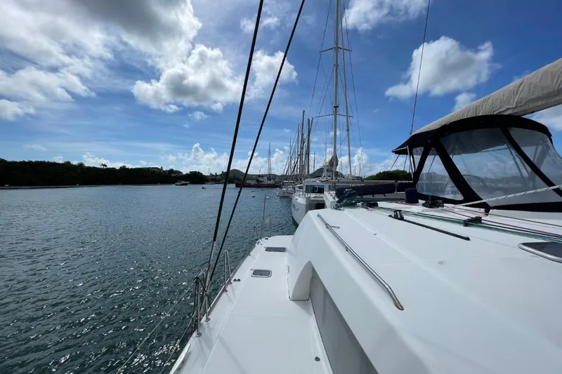 Tikiaora Yacht Photos Pics Sailing on a 2008 Lagoon 500 catamaran in a serene marina under a blue sky.