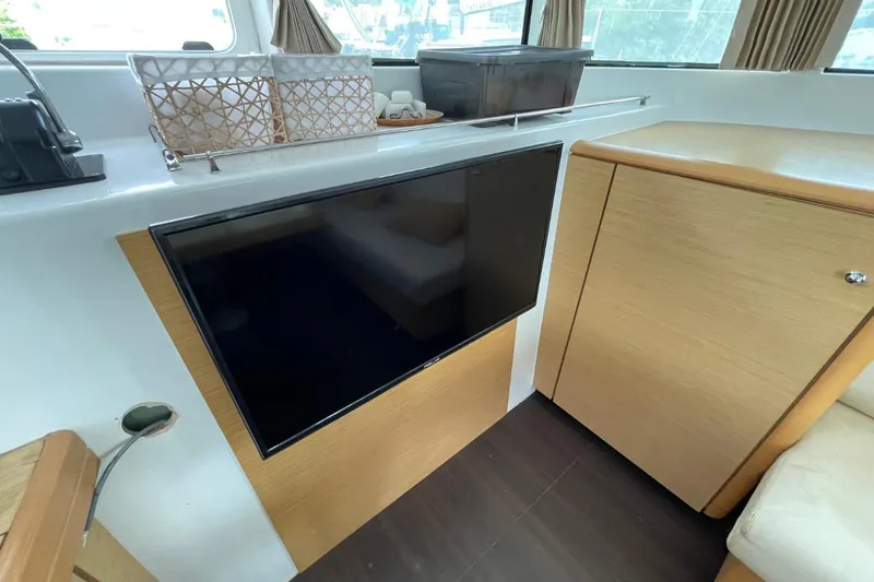Tikiaora Yacht Photos Pics Interior of 2008 Lagoon 500 yacht with TV and wooden cabinetry.